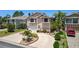 Charming two-story home featuring a circular driveway and lush tropical landscaping at 6121 Fjord Way, New Port Richey, FL 34652