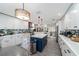Bright, updated kitchen with a navy island, stainless appliances, and stylish pendant lighting at 6121 Fjord Way, New Port Richey, FL 34652
