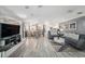 Open-concept living space showcasing tile floors and modern décor with a view to the kitchen at 6121 Fjord Way, New Port Richey, FL 34652