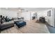 Open-concept living room and dining area with modern flooring and a comfortable seating arrangement at 6121 Fjord Way, New Port Richey, FL 34652