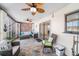 Enclosed patio featuring stone floors, two ceiling fans, and comfortable wicker seating, perfect for relaxation at 6121 Fjord Way, New Port Richey, FL 34652