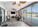 Enclosed patio featuring a ceiling fan and comfortable wicker seating with pool views at 6121 Fjord Way, New Port Richey, FL 34652