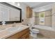 A well-lit bathroom features a tub and shower combo with light brown tile surround at 6812 Fountain Ave, Tampa, FL 33634