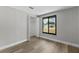 A simple bedroom has hard wood floors, neutral gray walls, and closet at 6812 Fountain Ave, Tampa, FL 33634