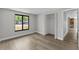 Bright bedroom features wood-look floors, closet and a large window offering natural light at 6812 Fountain Ave, Tampa, FL 33634