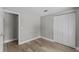 Bedroom features neutral gray walls, hardwood floors, and a double closet at 6812 Fountain Ave, Tampa, FL 33634
