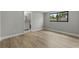 Bedroom with wood-look floors and a window with views of the neighborhood at 6812 Fountain Ave, Tampa, FL 33634