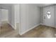 Hallway with wood-look floors leads to the foyer with a decorative front door at 6812 Fountain Ave, Tampa, FL 33634
