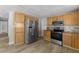 Well-equipped kitchen with wood cabinetry, stainless steel appliances, and ample counter space at 6812 Fountain Ave, Tampa, FL 33634