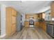 Spacious kitchen with wood cabinets, stainless steel appliances and modern flooring at 6812 Fountain Ave, Tampa, FL 33634