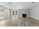 Bright living room with modern flooring, fireplace, and access to the backyard at 6812 Fountain Ave, Tampa, FL 33634
