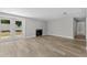 Open living room features a fireplace, hardwood floors, and sliding glass doors leading to the outside at 6812 Fountain Ave, Tampa, FL 33634