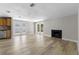 Bright living room with modern flooring, fireplace, and access to the backyard at 6812 Fountain Ave, Tampa, FL 33634