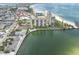 Aerial view showcasing the building's proximity to the beach, tennis courts, and swimming pool at 7150 Sunset Way # 405, St Pete Beach, FL 33706