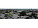 An aerial view of the community, showcasing parking, landscaping, and a distant city skyline at 7150 Sunset Way # 405, St Pete Beach, FL 33706