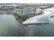 Scenic aerial view of waterfront condo building with beach access and a protected shoreline at 7150 Sunset Way # 405, St Pete Beach, FL 33706
