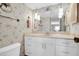 Bathroom vanity with white cabinets, sink, framed mirror, and vintage wall decor at 7150 Sunset Way # 405, St Pete Beach, FL 33706