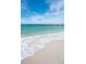 Beautiful beach with clear blue water and a rock barrier, perfect for swimming and relaxation at 7150 Sunset Way # 405, St Pete Beach, FL 33706