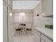 Eat in kitchen featuring a mosaic table, chandelier, and window with natural light at 7150 Sunset Way # 405, St Pete Beach, FL 33706