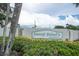 Community signage at the entrance showcasing the name and logo at 7150 Sunset Way # 405, St Pete Beach, FL 33706