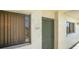 Condo front door featuring a secure screen door, window, and unit number at 7150 Sunset Way # 405, St Pete Beach, FL 33706