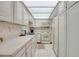 Bright kitchen with white appliances, ample counter space and tiled flooring at 7150 Sunset Way # 405, St Pete Beach, FL 33706