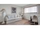 Cozy living room featuring a striped sofa, side table, and complementary decor at 7150 Sunset Way # 405, St Pete Beach, FL 33706