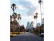 Palm-lined street leading to city buildings, offering a scenic and serene view at 7150 Sunset Way # 405, St Pete Beach, FL 33706