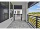 Inviting covered balcony with gray stone flooring overlooking the neighborhood at 7232 Sutton Ln, Sarasota, FL 34240