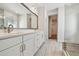 Modern bathroom featuring double sinks, a large mirror, and tiled flooring at 7232 Sutton Ln, Sarasota, FL 34240