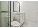 Modern bathroom featuring a walk-in shower with glass door, toilet, and vanity at 7232 Sutton Ln, Sarasota, FL 34240