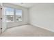 Cozy bedroom with carpet, natural light from the two windows, and a closet at 7232 Sutton Ln, Sarasota, FL 34240