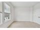 Well-lit bedroom features neutral carpet, a large window, and a closet for ample storage at 7232 Sutton Ln, Sarasota, FL 34240