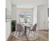 Bright dining area with round table, seating for four, and natural light from the window at 7232 Sutton Ln, Sarasota, FL 34240