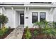 Inviting front entrance with stone walkway, black door, and manicured landscaping at 7232 Sutton Ln, Sarasota, FL 34240