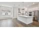 Modern kitchen with white cabinets, stainless steel appliances, and a large center island at 7232 Sutton Ln, Sarasota, FL 34240
