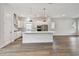 Modern, white kitchen with large island, stainless steel appliances, and hardwood floors at 7232 Sutton Ln, Sarasota, FL 34240