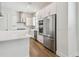 Contemporary kitchen with stainless steel appliances, subway tile backsplash, and bright white cabinetry at 7232 Sutton Ln, Sarasota, FL 34240