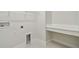 Functional laundry room with tiled floors, a countertop, and utility connections at 7232 Sutton Ln, Sarasota, FL 34240