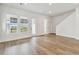 Living room features wood floors, neutral paint, recessed lighting, large windows, and staircase at 7232 Sutton Ln, Sarasota, FL 34240