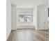 Bright living room featuring neutral paint, wood floors, recessed lighting, and a modern window seat at 7232 Sutton Ln, Sarasota, FL 34240