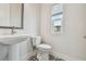 Stylish powder room with a pedestal sink, decorative tile flooring, and natural light at 7232 Sutton Ln, Sarasota, FL 34240