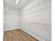 Bright walk-in closet with wire shelving and wood-look flooring offers ample storage space at 7232 Sutton Ln, Sarasota, FL 34240