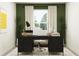 Stylish home office with a modern desk, chair, and serene green accents at 7776 Painted Sky Pl, Land O Lakes, FL 34637