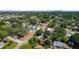 An aerial view of the home with the downtown skyline of the city in the background surrounded by mature trees at 785 52Nd N Ave, St Petersburg, FL 33703