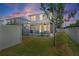 Backyard view of home features a screened patio, fenced yard, and outdoor seating area at 785 52Nd N Ave, St Petersburg, FL 33703