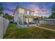 A spacious backyard with a screened-in porch, green grass, and a storage shed offers a relaxing outdoor living space at 785 52Nd N Ave, St Petersburg, FL 33703