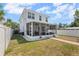 Spacious backyard with a screened patio, white fence, and lush green lawn, perfect for outdoor living at 785 52Nd N Ave, St Petersburg, FL 33703