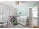 Bright Bedroom with a crib, rocker, and whimsical decor accents create a cozy space at 785 52Nd N Ave, St Petersburg, FL 33703