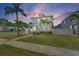 Inviting two-story home featuring a well-maintained lawn, lush landscaping, and a charming walkway to the front entrance at 785 52Nd N Ave, St Petersburg, FL 33703